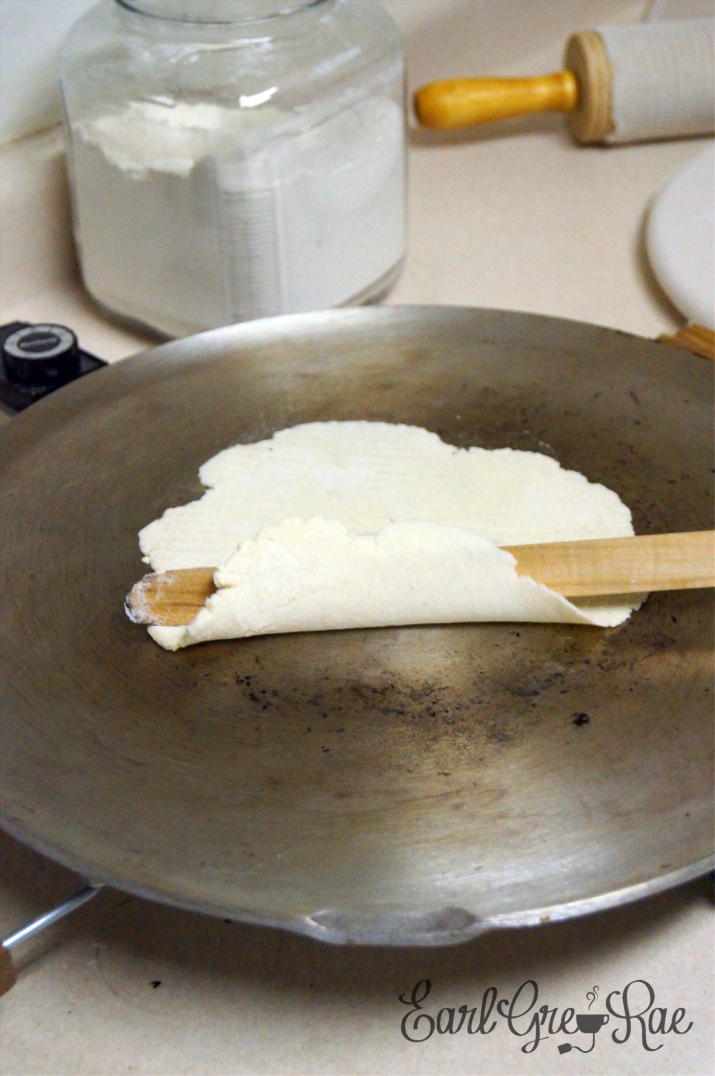 lefse on the grill with a lefse stick